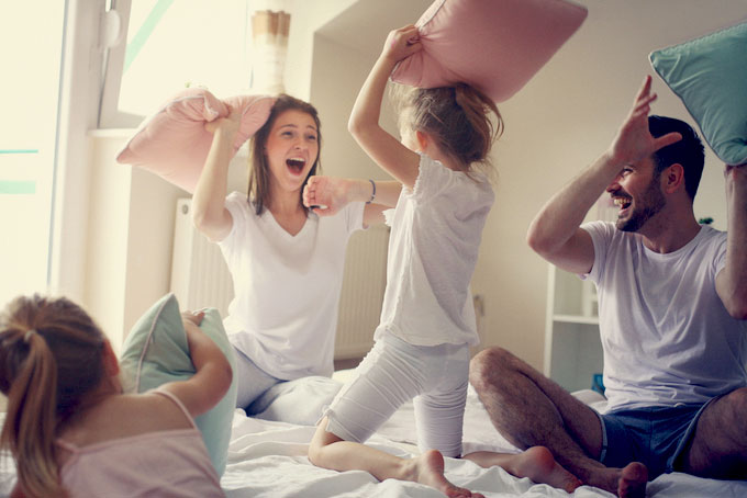 Family Playing with Best Sleep Accessories - Pillows