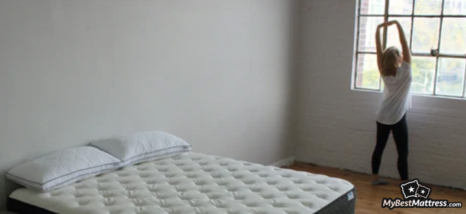 Bear Pro Mattress Review: woman standing near the Bear mattress. Bear Pro Mattress Review: woman standing near the Bear mattress.