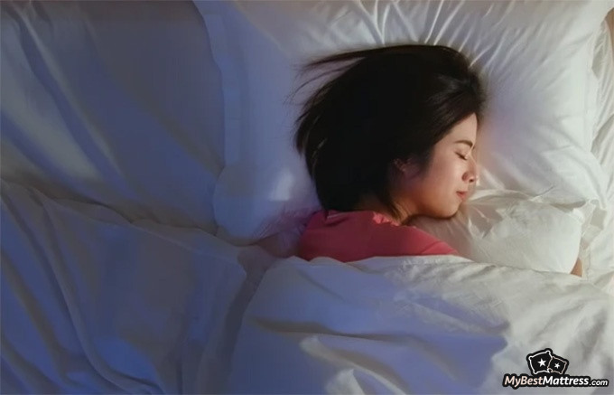 Bear Pro Mattress Review: woman lying on a pillow. Bear Pro Mattress Review: woman lying on a pillow.