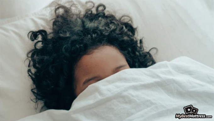 Bear Pro Mattress Review: woman sleeping on her Bear mattress. Bear Pro Mattress Review: woman sleeping on her Bear mattress.