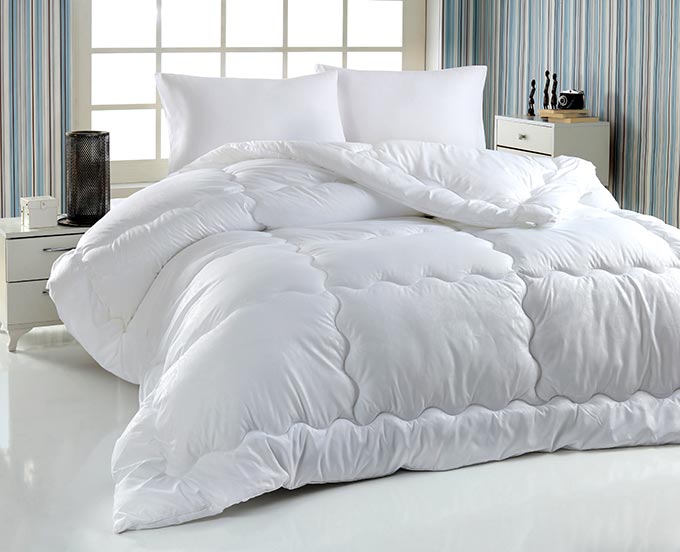Best comforter: a comforter on a bed.