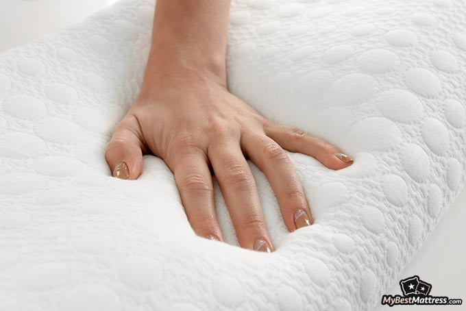 Best memory foam pillow: a woman's hand on a memory foam pillow.