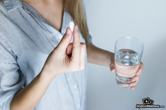 Best over-the-counter sleep aid: female taking a pill