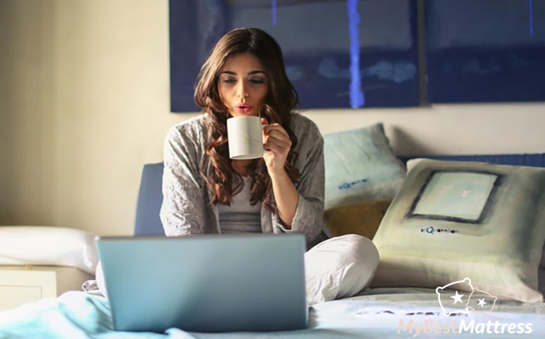 Best place to buy a mattress: featured image of a girl sitting on a bed. Best place to buy a mattress: featured image of a girl sitting on a bed.