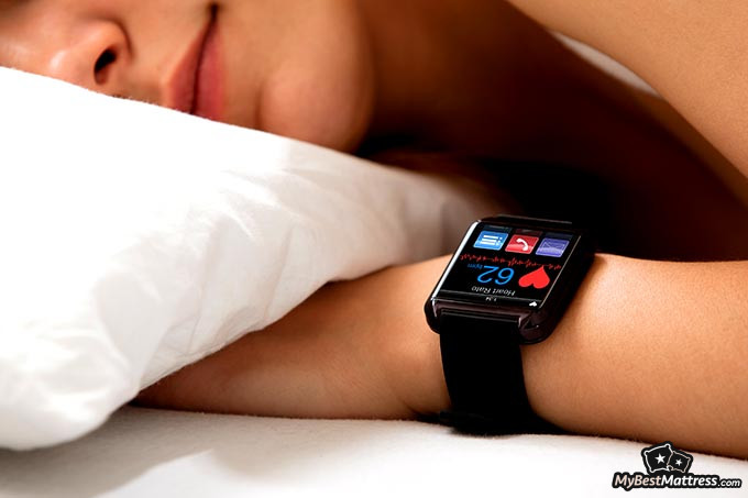 Best sleep tracker: a woman sleeping with her smartwatch tracking her sleep.