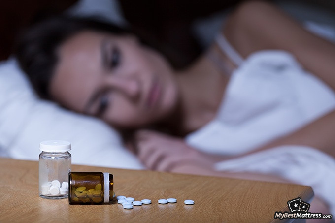 Best Tea For Sleep: Woman contemplating taking sleep medication.