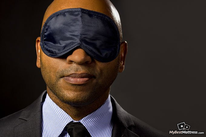 How long should I nap: businessman wearing an eye-mask