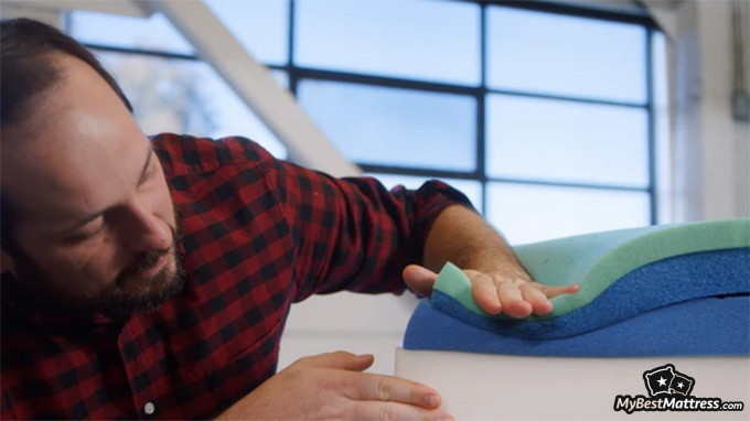 Casper Element Review: man checking the mattress layers. Casper Element Review: man checking the mattress layers.