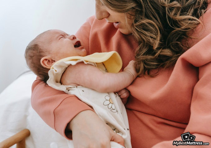 Do babies dream: baby crying in woman's arms. Do babies dream: baby crying in woman's arms.