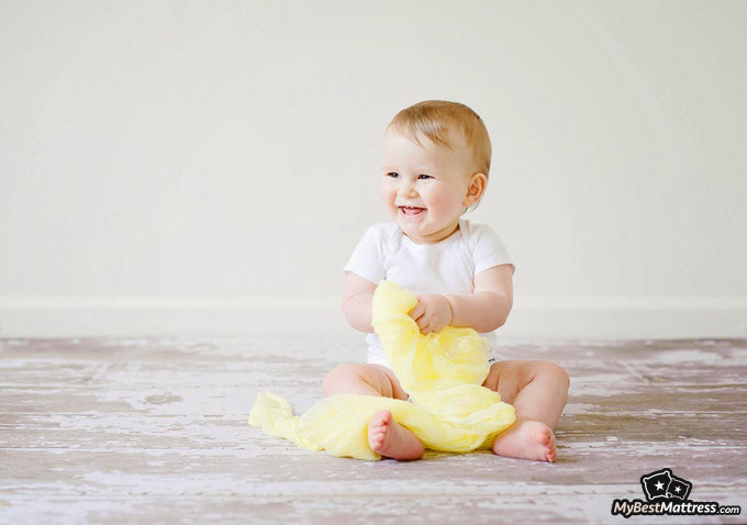 Do Babies Dream: baby smiling while holding a blanket. Do Babies Dream: baby smiling while holding a blanket.