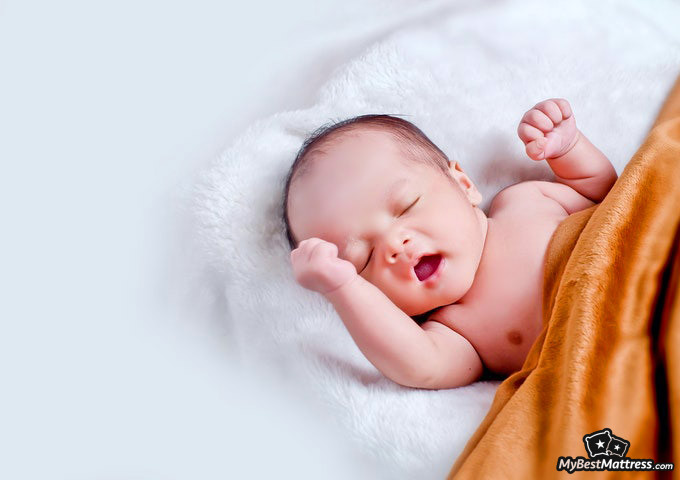 Do Babies Dream: baby yawning in bed. Do Babies Dream: baby yawning in bed.