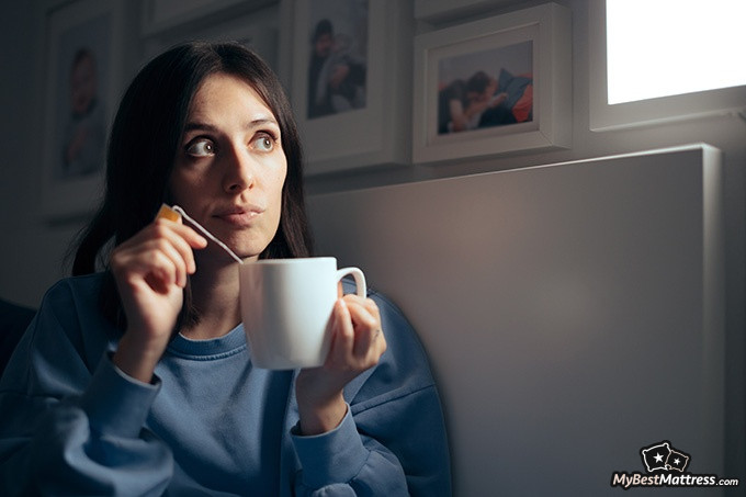 Green Tea Before Bed: Woman with insomnia drinking tea before bed.