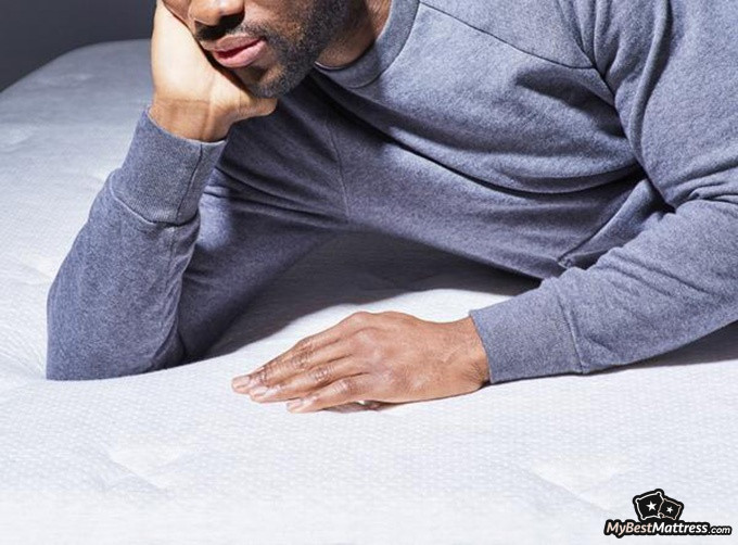 Helix Midnight mattress review: man lying down on a Helix Midnight Luxe mattress