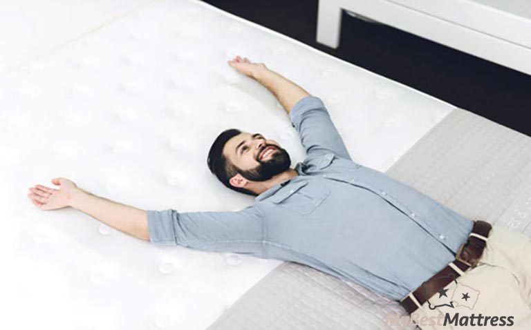 How to choose a mattress: a man laying on a bed. How to choose a mattress: a man laying on a bed.
