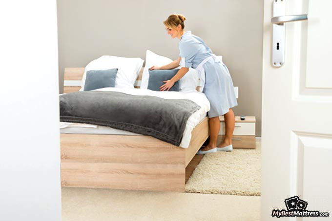 How to clean a mattress: woman making a bed. How to clean a mattress: woman making a bed.