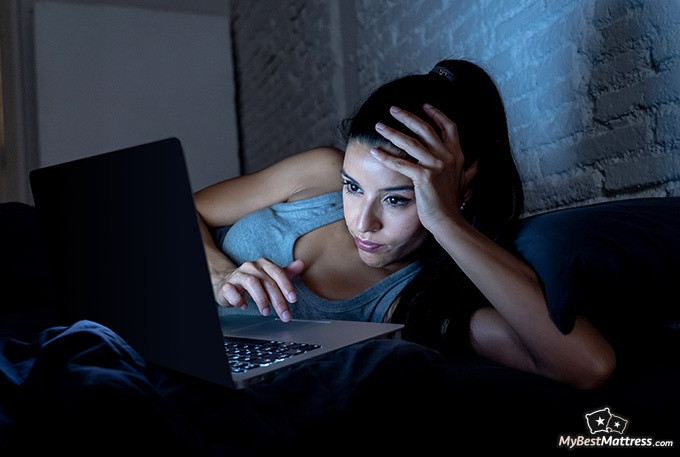 How to cure insomnia: a woman on a laptop, in bed. How to cure insomnia: a woman on a laptop, in bed.