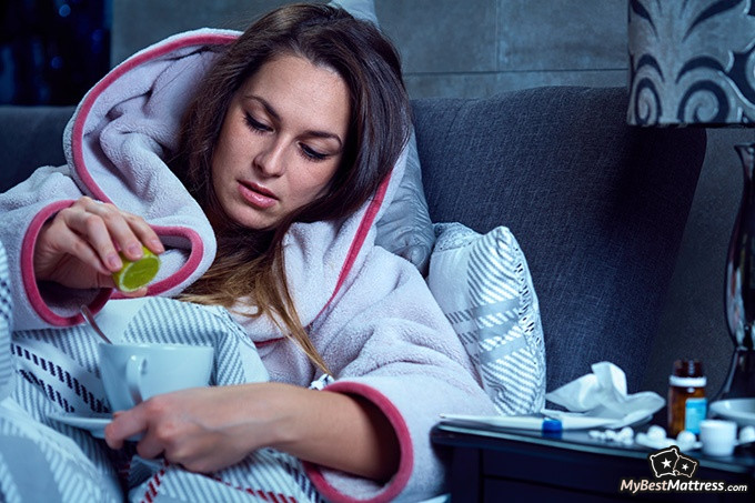 How To Sleep With A Cold: woman trying to help her cold at night.