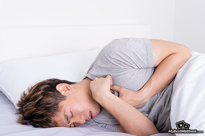 How to Stop Drooling: guy suffering from acid reflux in bed.