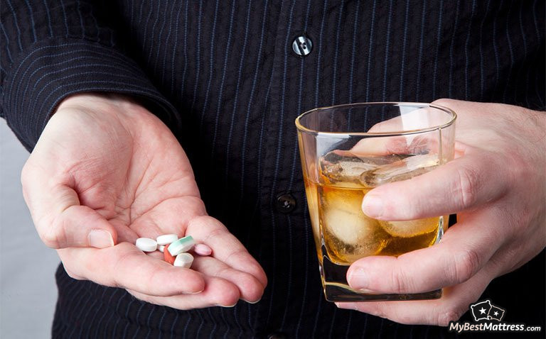 Melatonin an Alcohol: man holding a glass of alcohol and pills Melatonin an Alcohol: man holding a glass of alcohol and pills