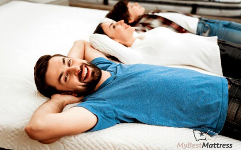 Mattress buying guide: people laying on a mattress. Mattress buying guide: people laying on a mattress.