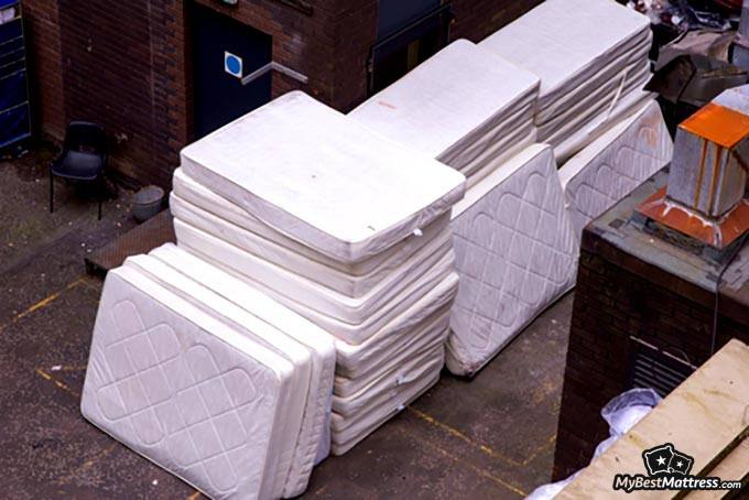 Mattress disposal: a pile of white mattresses. Mattress disposal: a pile of white mattresses.