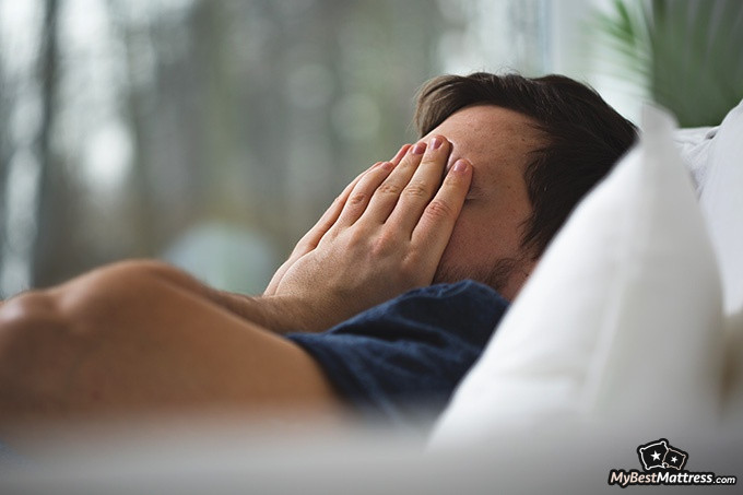 Night terrors vs nightmares: a tired man is covering his face with his hands Night terrors vs nightmares: a tired man is covering his face with his hands