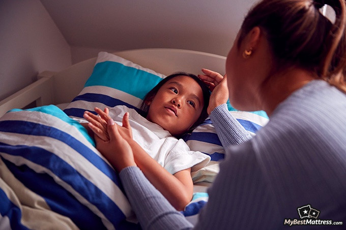 Night terrors vs nightmares: a mother is talking to her daughter before sleep Night terrors vs nightmares: a mother is talking to her daughter before sleep