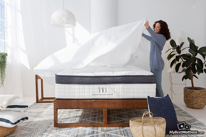 Brentwood Home mattress review: a woman making the bed.