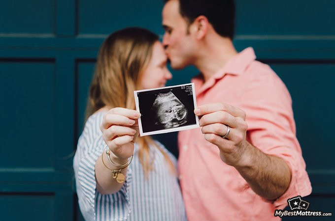 Nausea in the morning: couple holding baby picture. Nausea in the morning: couple holding baby picture.
