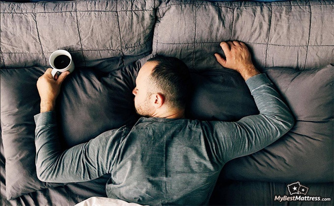 Sleep Number P6 Reviews: man sleeping on his stomach with a cup.