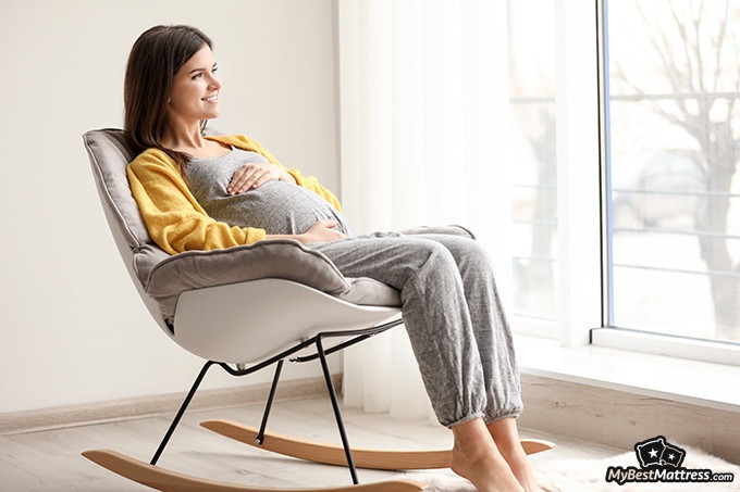 Sleeping Sitting Up - a pregnant woman sitting in a chair.