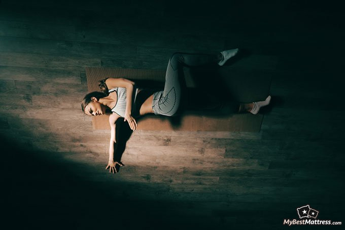 Natural sleep aid: woman stretching in the dark Natural sleep aid: woman stretching in the dark