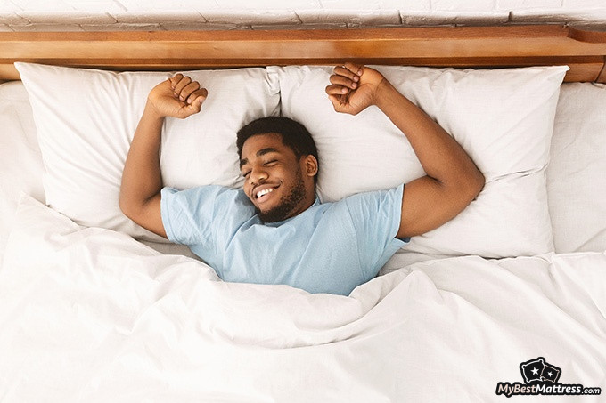 Tuft and Needle Hybrid mattress review: a man waking up. Tuft and Needle Hybrid mattress review: a man waking up.