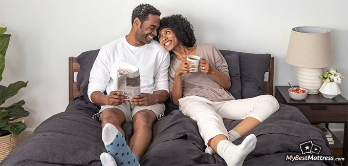 Tuft and Needle Hybrid mattress review: A couple sitting on the bed. Tuft and Needle Hybrid mattress review: A couple sitting on the bed.