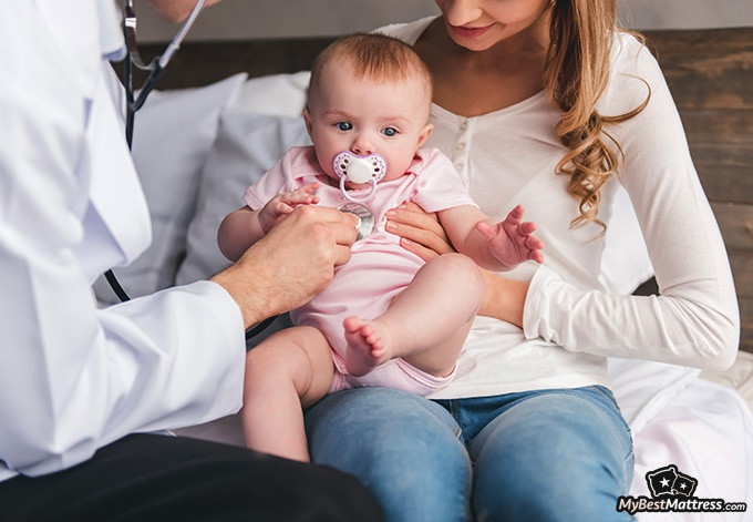 What is Parasomnia: a mother is holding a baby during a pediatrician's examination What is Parasomnia: a mother is holding a baby during a pediatrician's examination