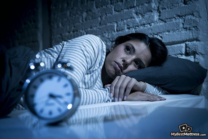 how to make a weighted blanket: woman not being able to sleep