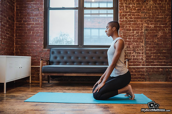 Yoga before bed: a woman is getting ready to do yoga.